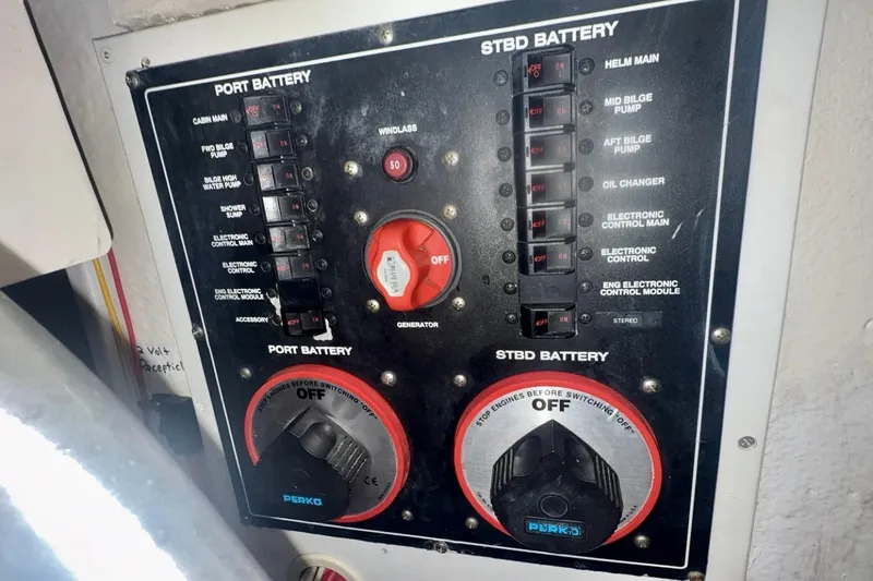 Slide: The Image of Control panel of a 2004 Luhrs 41 Convertible boat showing battery switches and circuit breakers. - 61