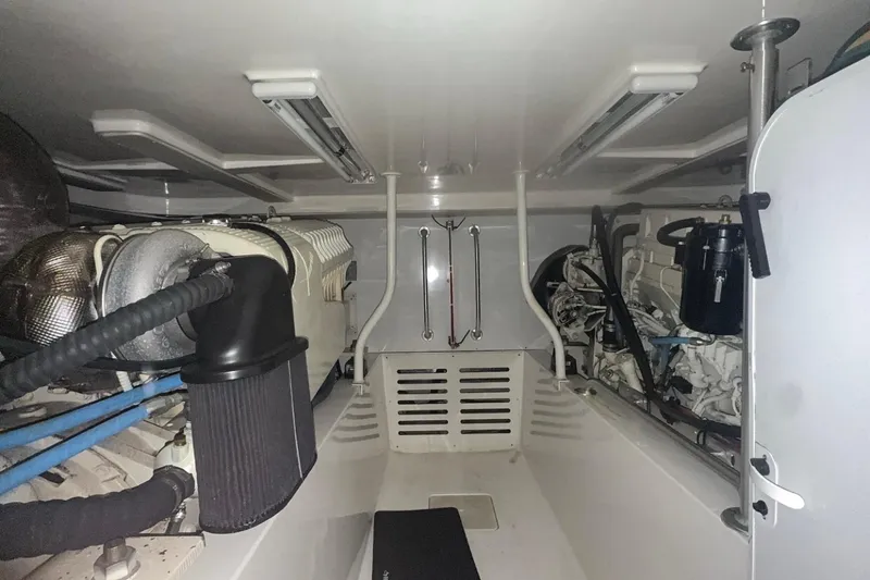 Slide: The Image of Engine room of a 2004 Luhrs 41 Convertible boat, showcasing mechanical components. - 63