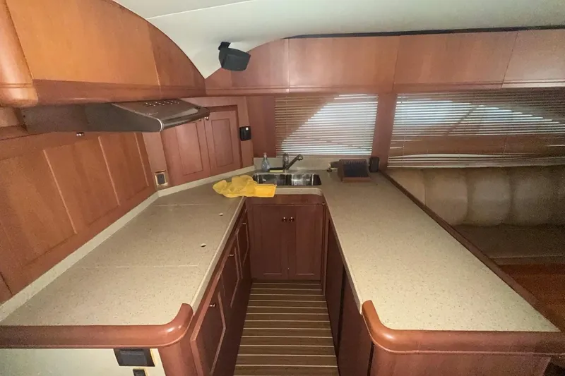 Slide: The Image of 2004 Luhrs 41 Convertible yacht kitchen with wooden cabinetry and countertop. - 66