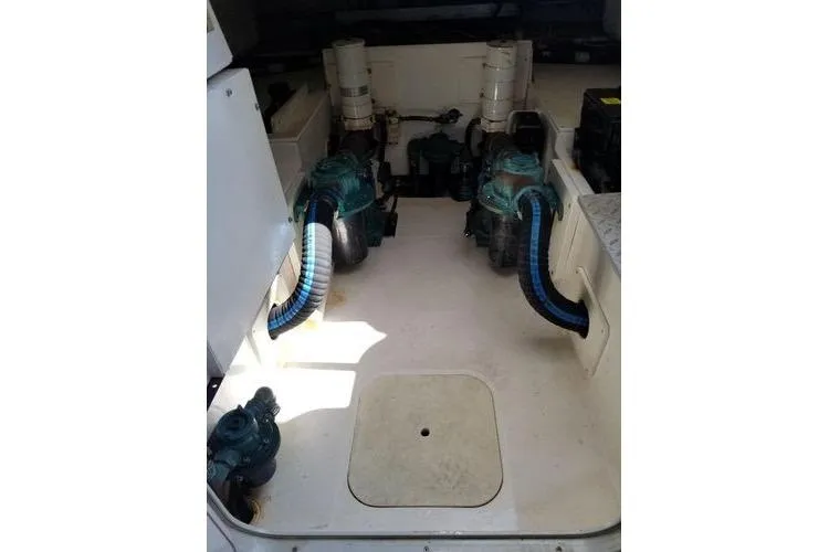 Slide: The Image of Engine room of 2005 Luhrs 41 Convertible boat with visible machinery and hoses. - 7