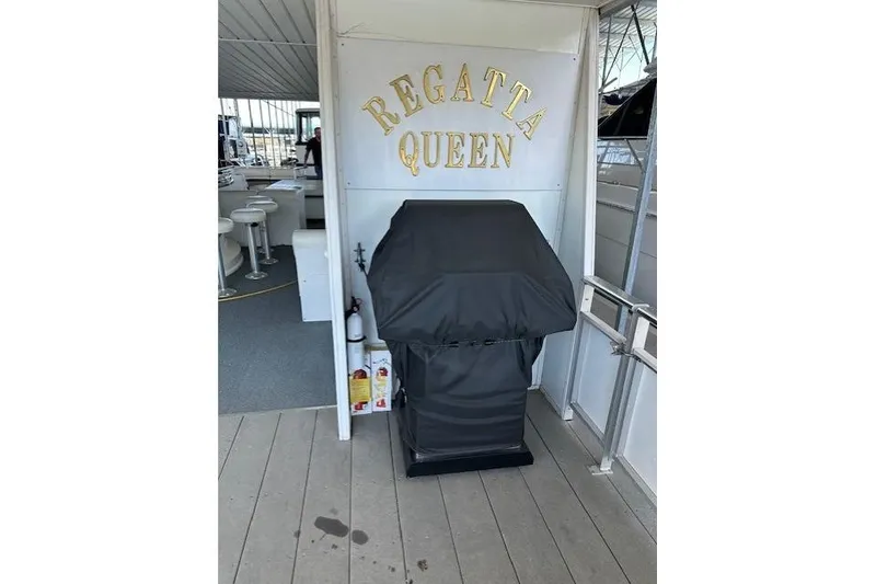 Slide: The Image of 2008 Destination Yachts 45X14 houseboat deck with chairs under covered marina. - 13