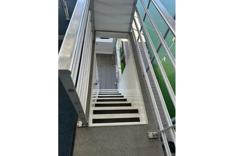 Slide: The Image of 2008 Destination Yachts 45X14 houseboat with upper deck, docked in a marina. - 18