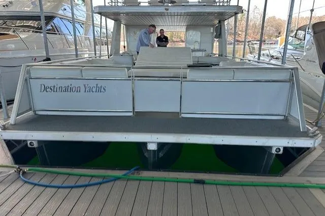 Slide: The Image of 2008 Destination Yachts 45X14 houseboat docked in a marina under a covered slip. - 19