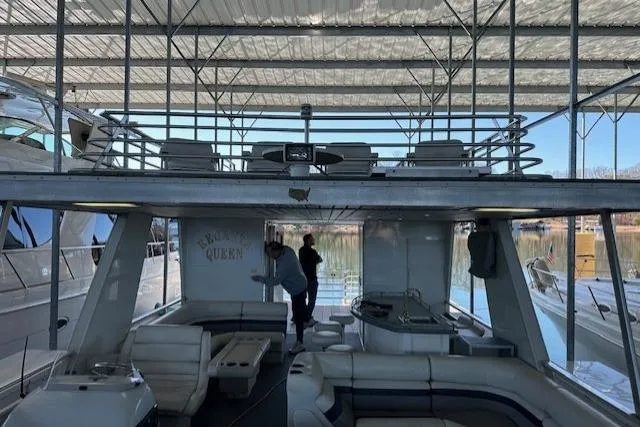 Slide: The Image of 2008 Destination Yachts 45X14 houseboat docked under a covered marina. - 20