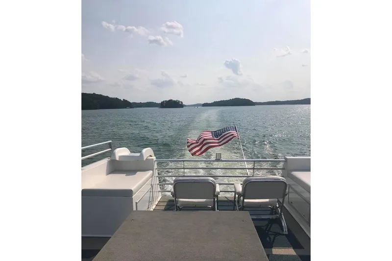 Slide: The Image of 2008 Destination Yachts 45X14 on a lake, American flag waving, sunny day. - 31