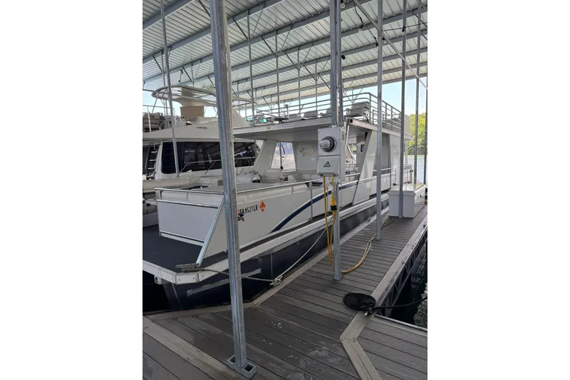 Slide: The Image of 2008 Destination Yachts 45X14 houseboat docked in a covered marina. - 34