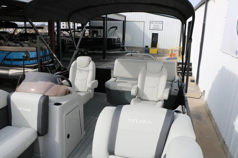 Slide: The Image of 2025 Sylvan MIRAGE 822 CLZ DH pontoon boat interior with plush seating and helm. - 13
