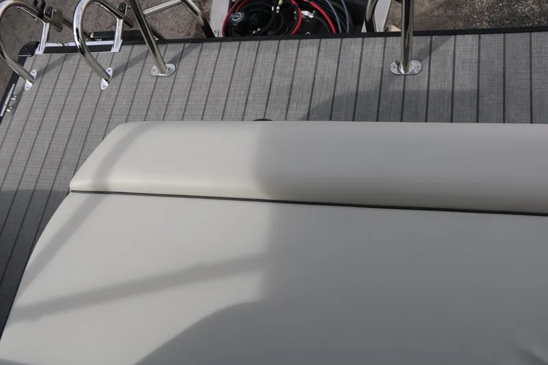 Slide: The Image of 2025 Sylvan MIRAGE 822 CLZ DH boat deck with cushioned seating and metal railings. - 20