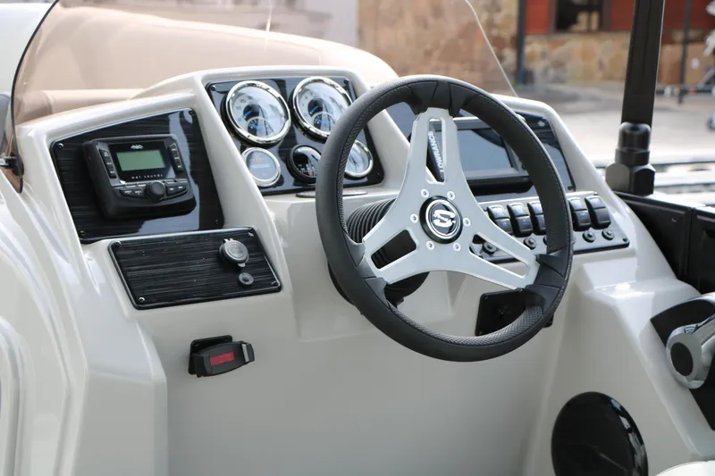 Slide: The Image of 2025 Sylvan MIRAGE 822 CLZ DH boat dashboard with steering wheel and control panel. - 26