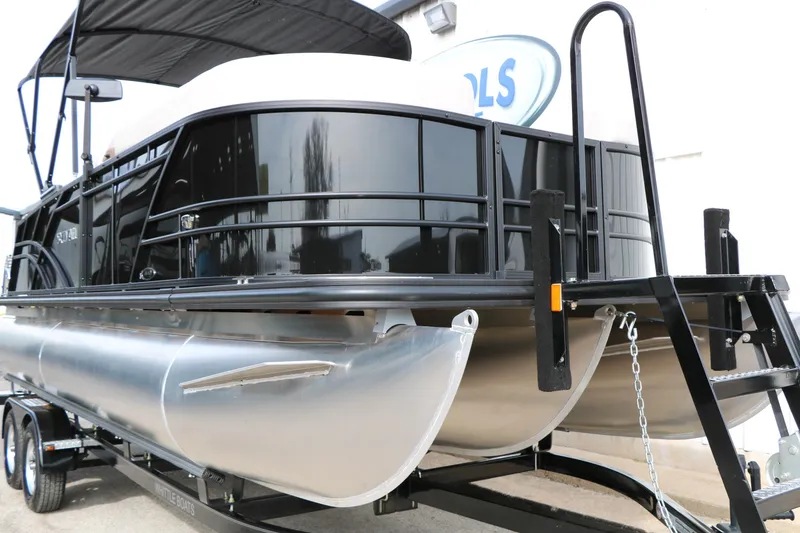 Slide: The Image of 2025 Sylvan MIRAGE 822 CLZ DH pontoon boat on trailer, black and silver design. - 4