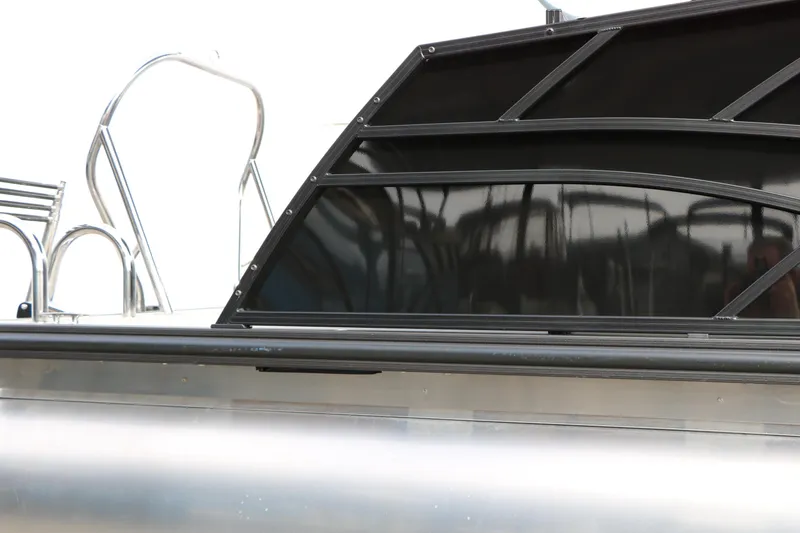 Slide: The Image of 2025 Sylvan MIRAGE 822 CLZ DH pontoon boat with sleek black paneling. - 7