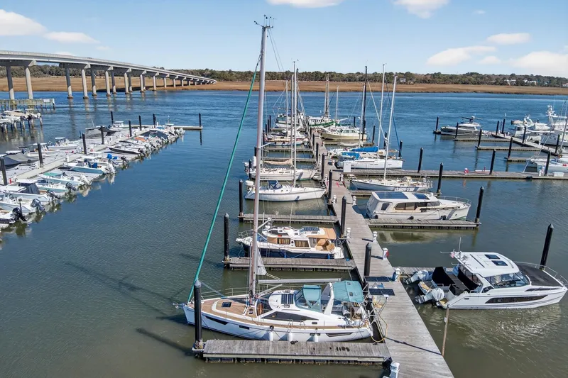 Slide: The Image of Marina with Southerly 420 sailboat, 2024 model, docked among various boats. - 2