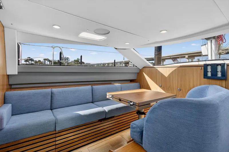 Slide: The Image of Luxurious interior of 2024 Southerly 420 yacht with blue seating and wooden accents. - 29