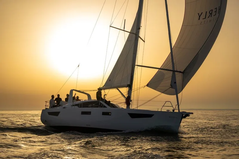 Slide: The Image of 2024 Southerly 420 "Off the Grid" sailboat cruising at sunset with silhouetted crew. - 42