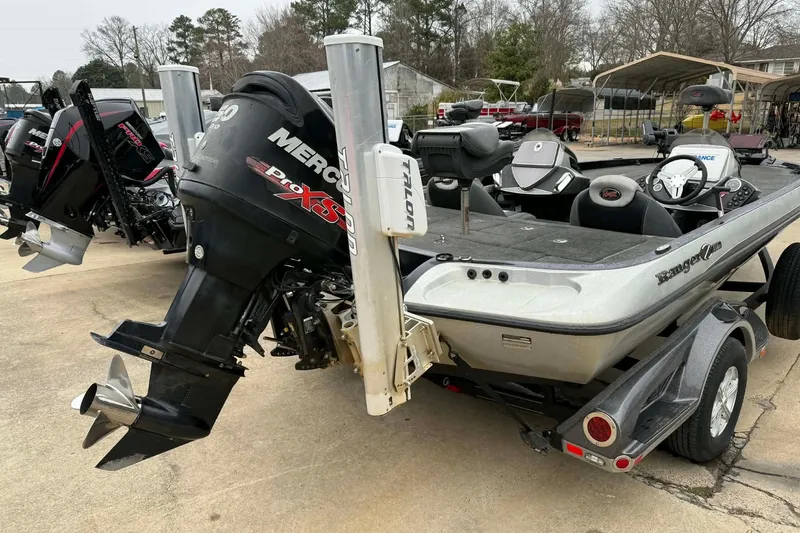 Slide: The Image of 2015 Ranger Z118 Comanche boat with Mercury Pro XS engine, parked outdoors. - 0