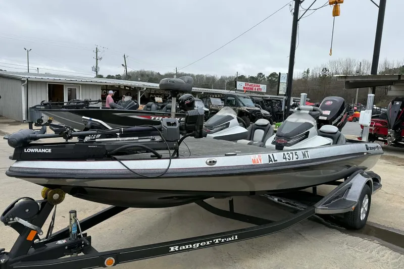 Slide: The Image of 2015 Ranger Z118 Comanche boat on trailer at dealership, featuring Lowrance equipment. - 5