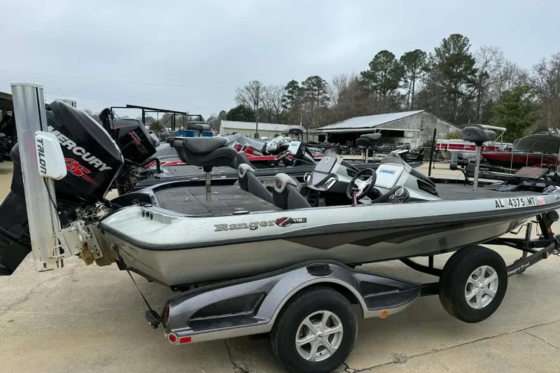 Slide: The Image of 2015 Ranger Z118 Comanche boat with Mercury engine on trailer, parked outdoors. - 7