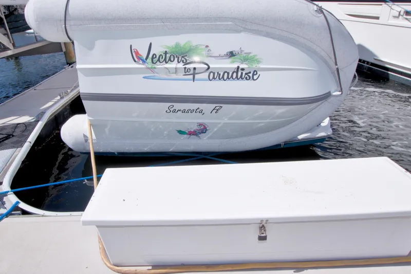 Slide: The Image of 2007 Meridian 459 Motoryacht docked in Sarasota, Florida, with "Vectors to Paradise" signage. - 101