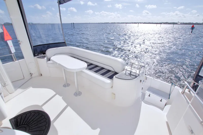 Slide: The Image of 2007 Meridian 459 Motoryacht deck with seating, table, and ocean view. - 16