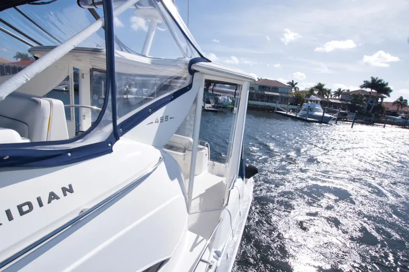 Slide: The Image of 2007 Meridian 459 Motoryacht on sunny waterfront, showcasing sleek design and luxury features. - 19