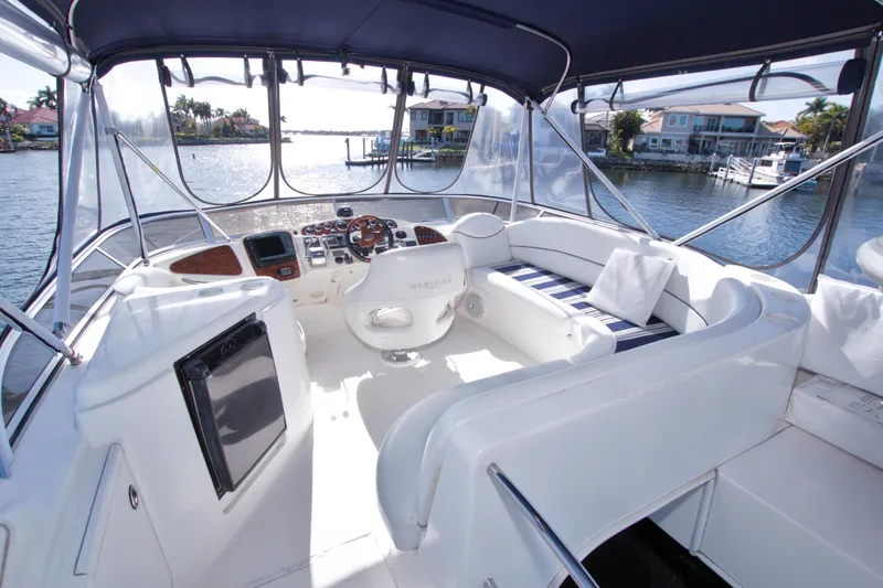 Slide: The Image of Luxurious 2007 Meridian 459 Motoryacht interior with elegant seating and scenic waterfront view. - 28