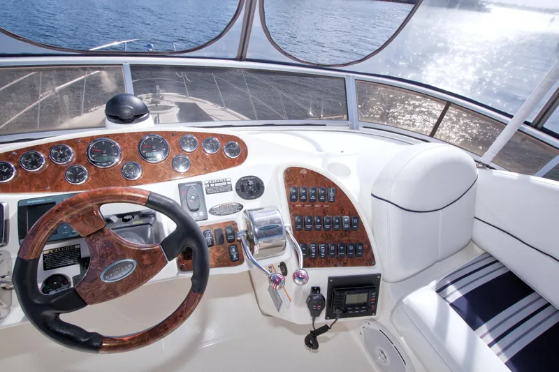 Slide: The Image of 2007 Meridian 459 Motoryacht helm with wood accents and ocean view. - 33