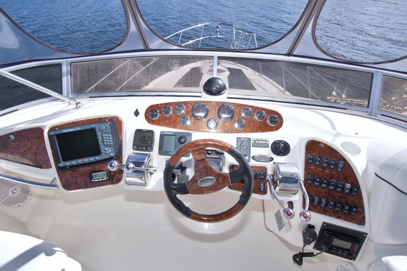 Slide: The Image of 2007 Meridian 459 Motoryacht helm with wood accents and navigational instruments. - 34