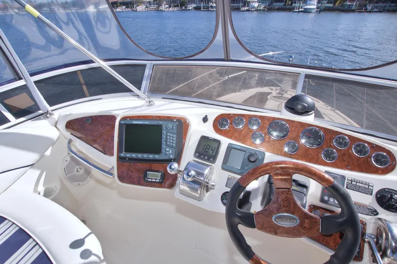 Slide: The Image of 2007 Meridian 459 Motoryacht helm with wood accents and navigation instruments on a sunny day. - 35