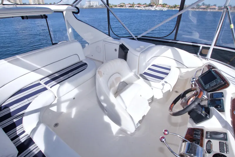 Slide: The Image of 2007 Meridian 459 Motoryacht cockpit with white seating and navigation controls. - 36