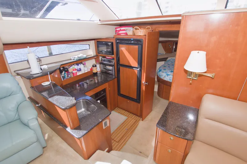 Slide: The Image of Luxurious 2007 Meridian 459 Motoryacht interior with modern kitchen and cozy seating area. - 45