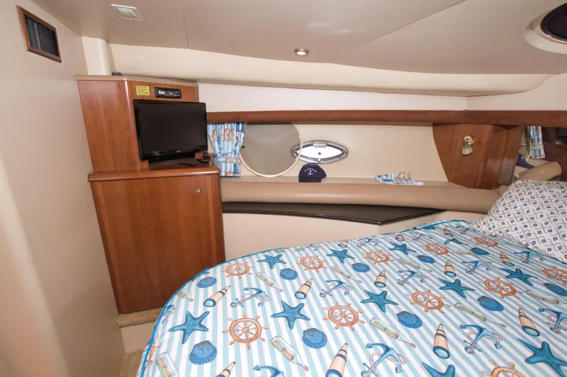 Slide: The Image of Luxurious 2007 Meridian 459 Motoryacht bedroom with nautical-themed bedding and TV. - 49
