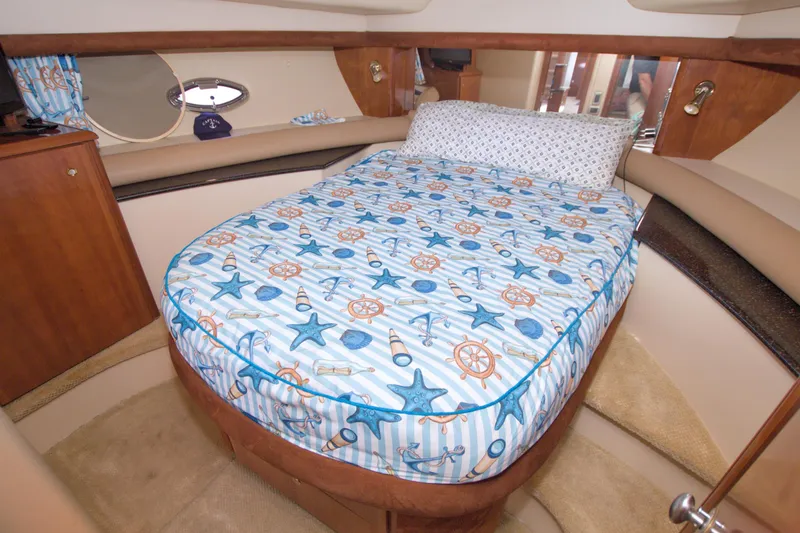 Slide: The Image of Luxurious 2007 Meridian 459 Motoryacht cabin with nautical-themed bedding. - 50