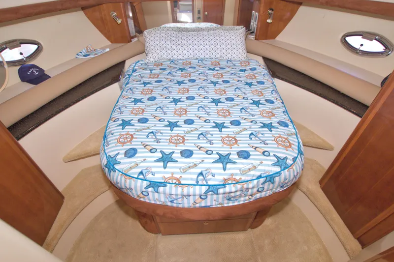 Slide: The Image of 2007 Meridian 459 Motoryacht cabin with nautical-themed bedding and wooden accents. - 51