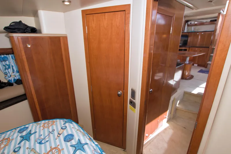 Slide: The Image of Interior of 2007 Meridian 459 Motoryacht with wooden doors and nautical-themed bedding. - 53