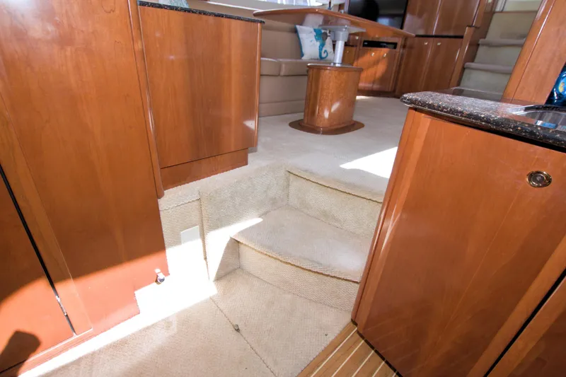 Slide: The Image of Interior of 2007 Meridian 459 Motoryacht with wooden cabinetry and carpeted steps. - 58