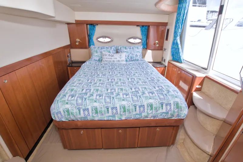 Slide: The Image of Luxurious bedroom interior of 2007 Meridian 459 Motoryacht with nautical-themed bedding. - 62