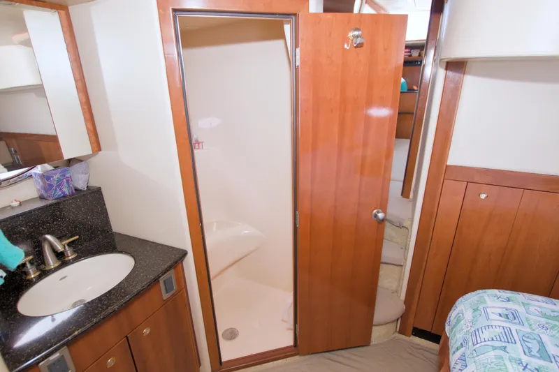 Slide: The Image of 2007 Meridian 459 Motoryacht bathroom with wooden cabinetry and modern fixtures. - 68