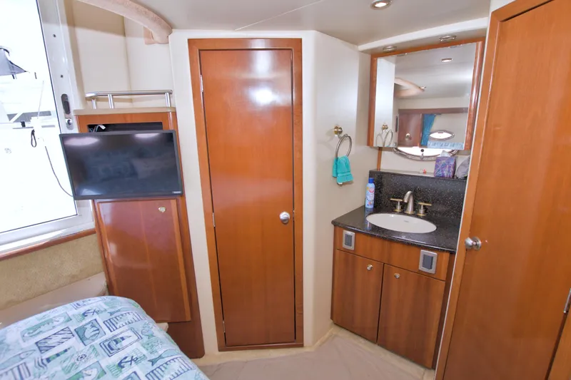 Slide: The Image of 2007 Meridian 459 Motoryacht interior with wood cabinetry, sink, and mounted TV. - 69
