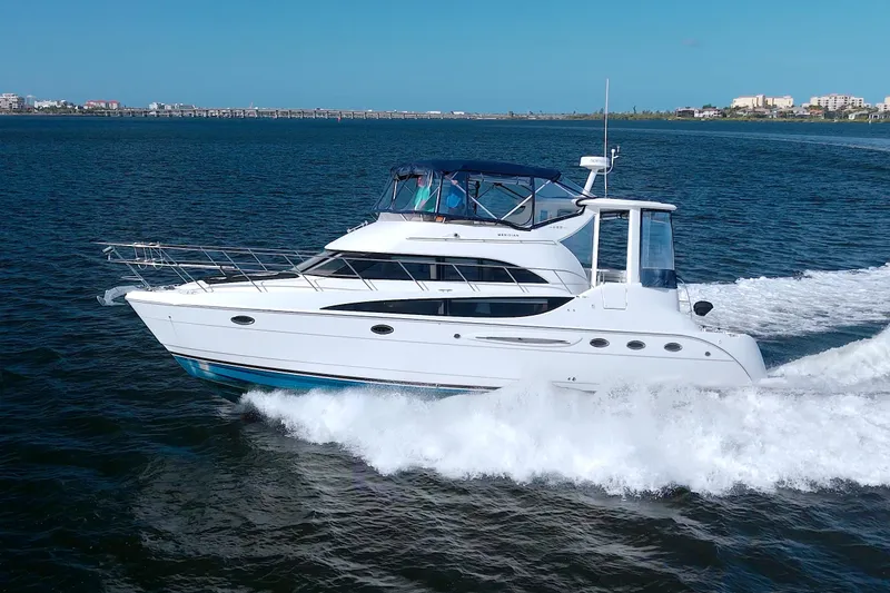 Slide: The Image of 2007 Meridian 459 Motoryacht cruising on open water under clear blue skies. - 8