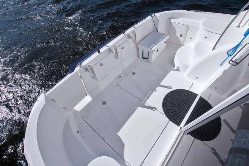 Slide: The Image of 2007 Meridian 459 Motoryacht deck with seating and storage, cruising on open water. - 91