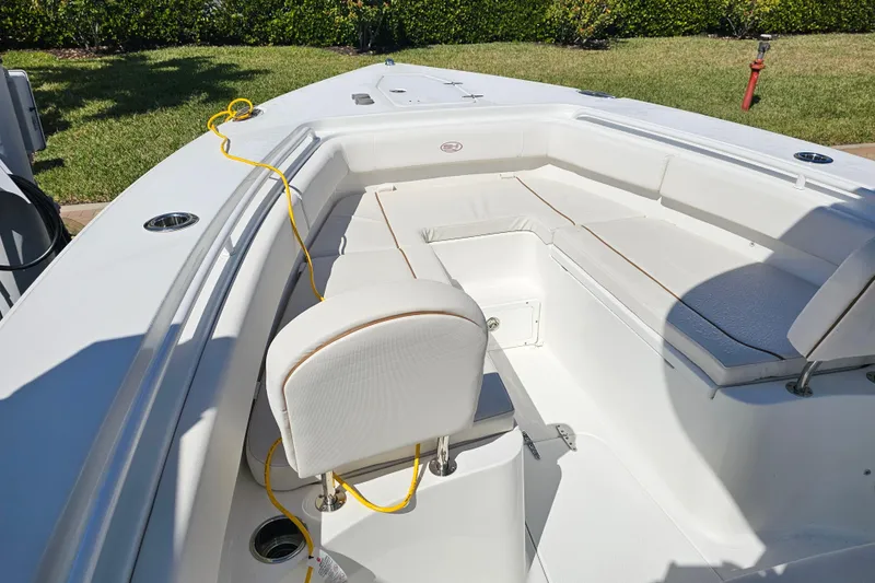 Slide: The Image of 2021 Sea Hunt Gamefish 27 Forward Seating boat with white cushioned seating. - 15