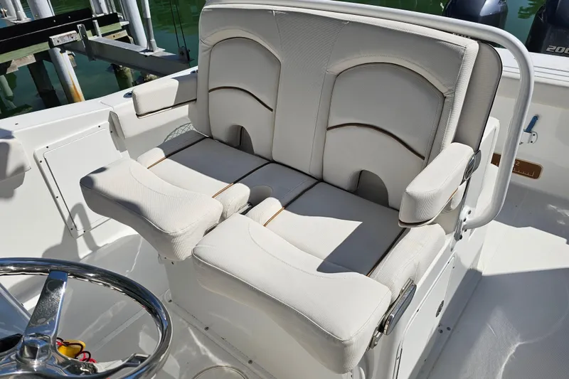 Slide: The Image of 2021 Sea Hunt Gamefish 27 boat with forward seating, featuring comfortable white upholstery. - 17