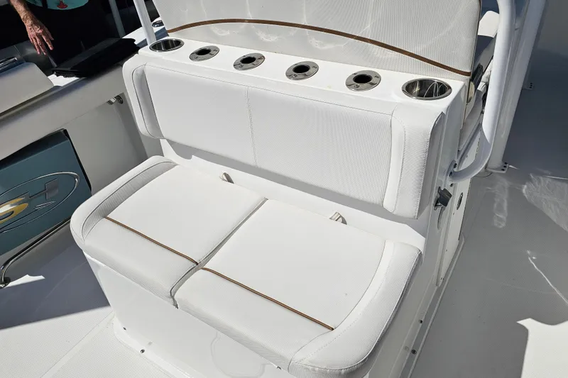 Slide: The Image of 2021 Sea Hunt Gamefish 27 Forward Seating with white cushioned seats and cup holders. - 19