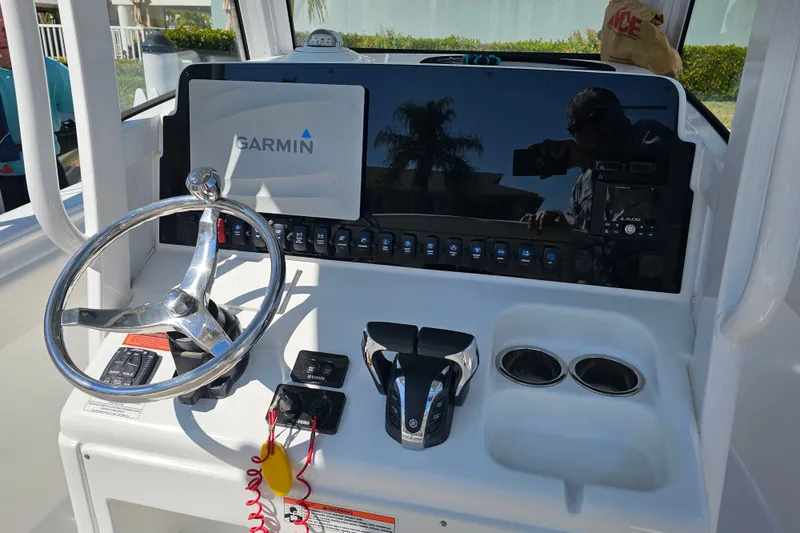 Slide: The Image of 2021 Sea Hunt Gamefish 27 helm with Garmin display and dual cup holders. - 30