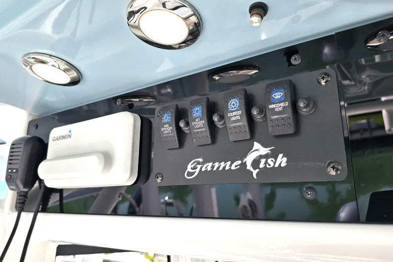 Slide: The Image of 2021 Sea Hunt Gamefish 27 control panel with switches and Garmin device. - 35