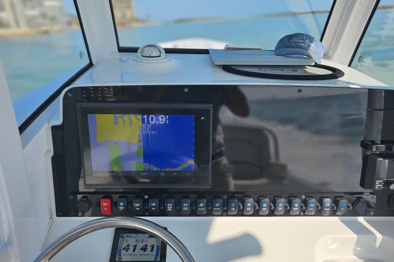 Slide: The Image of 2021 Sea Hunt Gamefish 27 dashboard with Garmin navigation display and controls. - 45