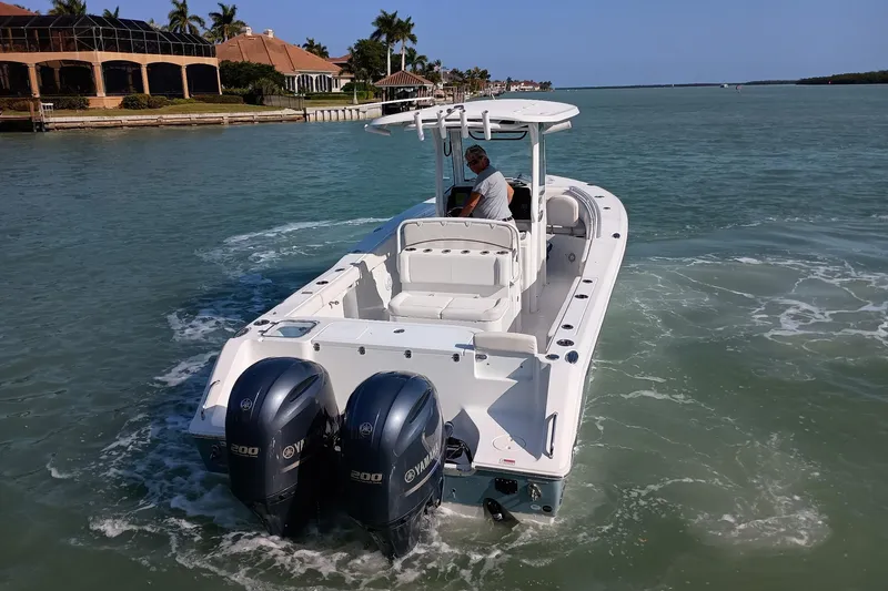 Slide: The Image of 2021 Sea Hunt Gamefish 27 boat cruising in a scenic waterway. - 5