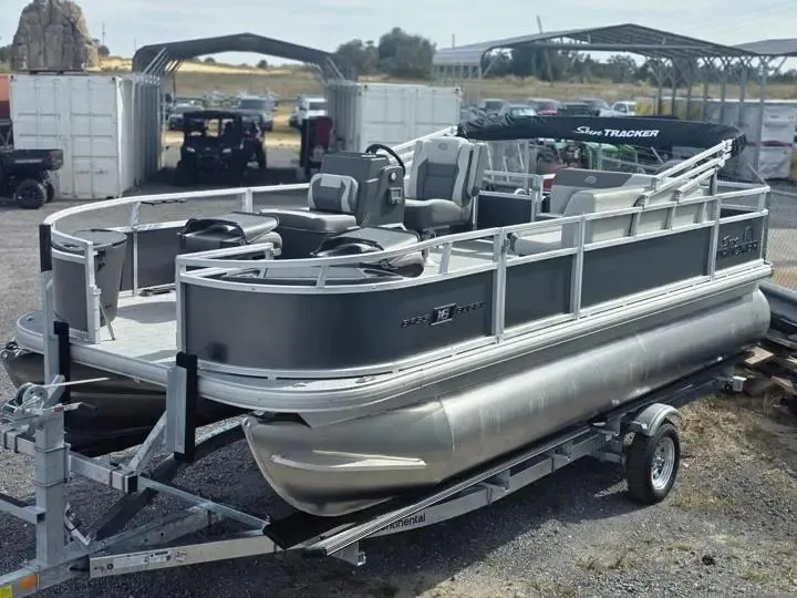 The Image of 2026 Sun Tracker Bass Buggy 18 DLX pontoon boat on trailer. - 1