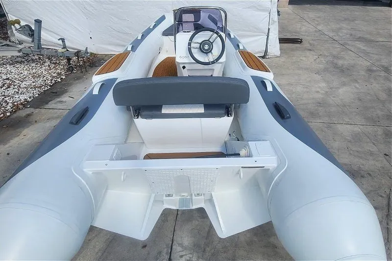 Slide: The Image of 2025 Gala A400L inflatable boat with steering console and seating, displayed on concrete surface. - 4