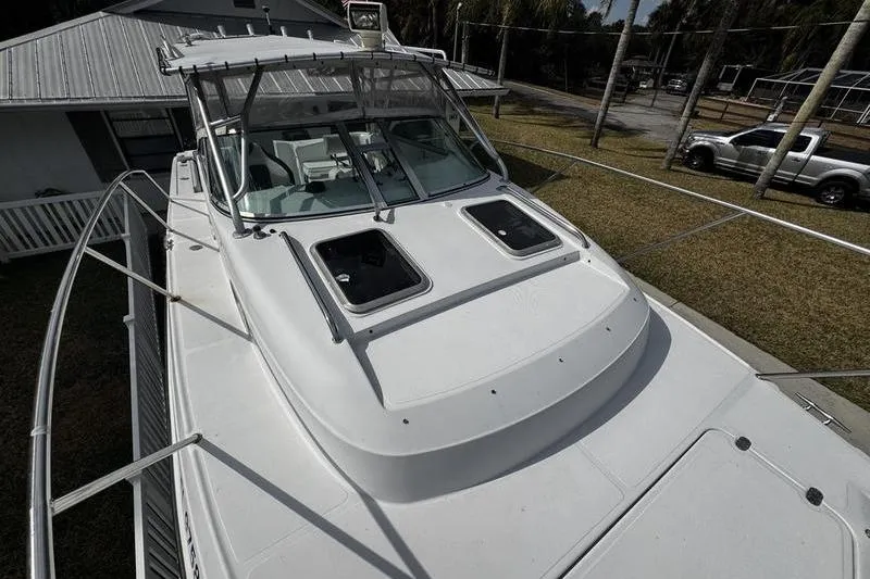Slide: The Image of 2001 Glacier Bay 260 Canyon Runner boat, docked, with visible cabin and deck features. - 11